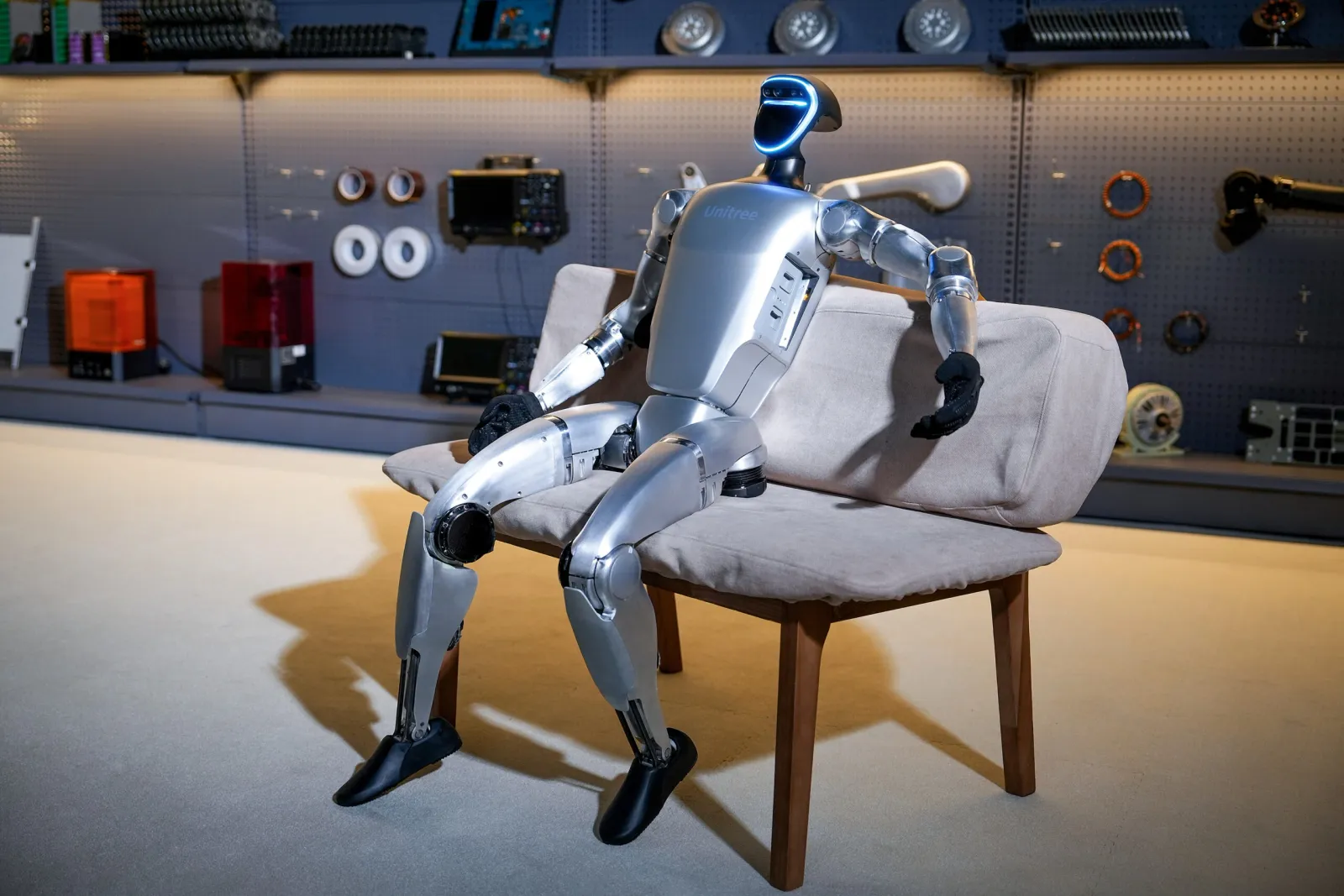A Syria Robots humanoid robot seated in a workshop